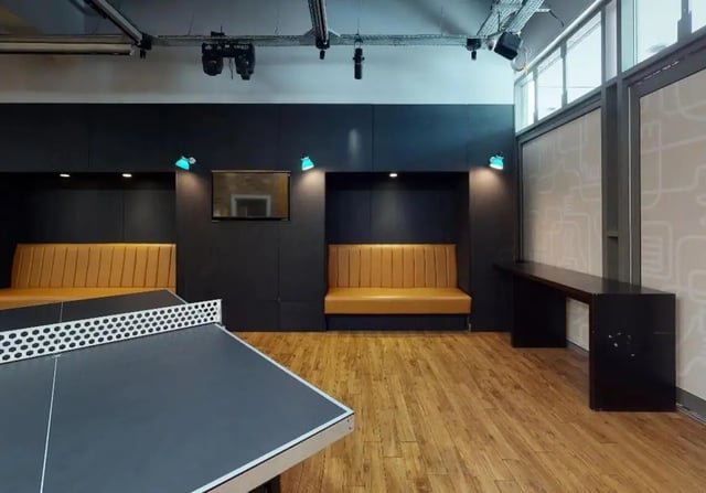 Ping pong table orange benches long table lounge area at iQ Wilmslow Park in Manchester Student Accommodation