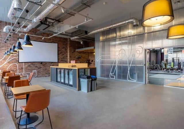 Tables chairs bar fridges gym area lounge at iQ Wilmslow Park in Manchester Student Accommodation