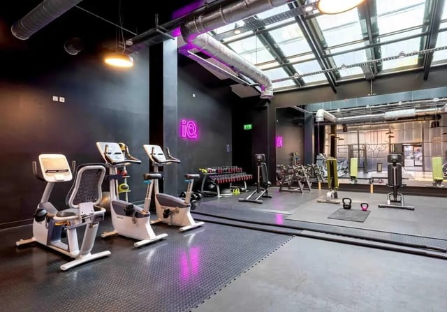 Exercise bikes and weights in modern gym at iQ Wilmslow Park in Manchester Student Accommodation