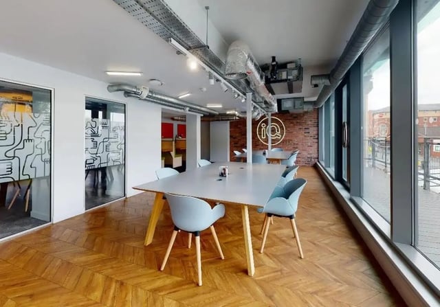 Large table with blue chairs study area at iQ Wilmslow Park in Manchester Student Accommodation