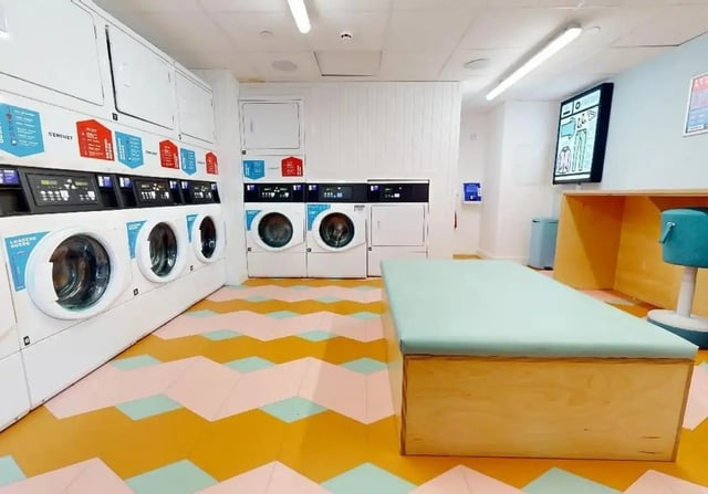 Washing machines dryers and seating area laundry room at iQ Signal Place in Nottingham Student Accommodation
