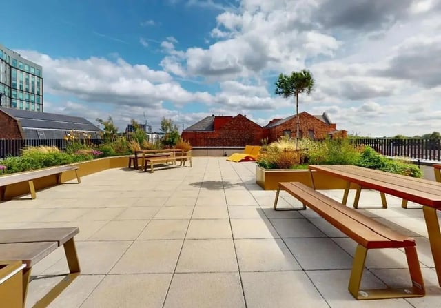 Picnic tables and benches on rooftop playing area at iQ Signal Place in Nottingham Student Accommodation