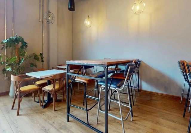 Tables chairs plant and industrial lighting communal area at iQ Signal Place in Nottingham Student Accommodation