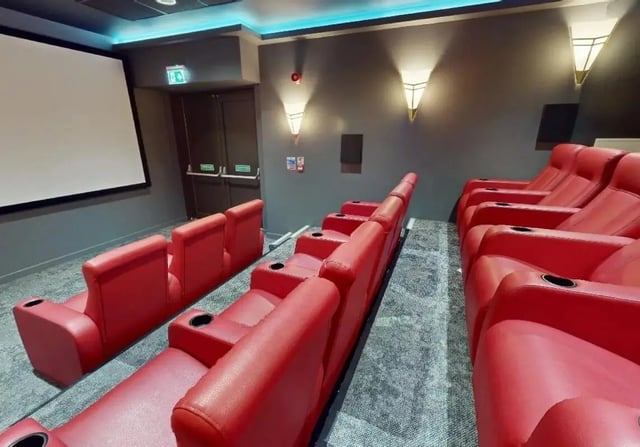 Red cinema seats with cup holders screening room at iQ Signal Place in Nottingham Student Accommodation