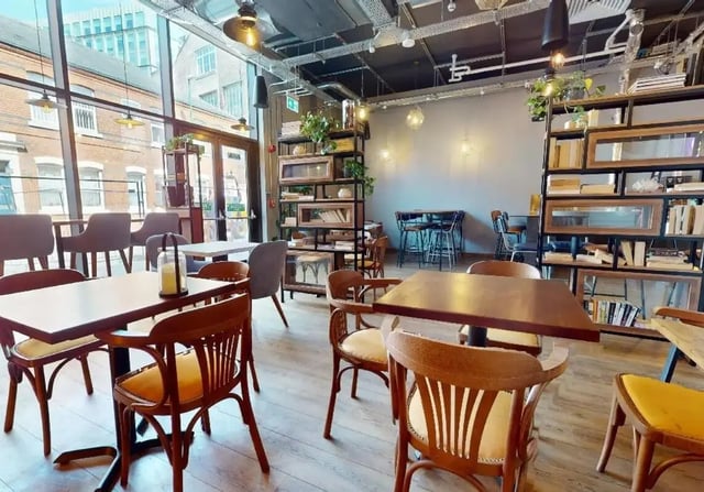 Wooden tables chairs and shelves common area at iQ Signal Place in Nottingham Student Accommodation