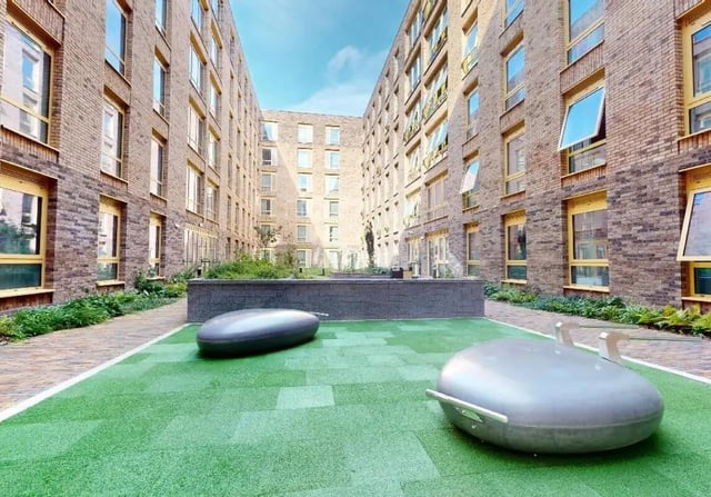 Modern brick building courtyard with seating exterior at iQ Signal Place in Nottingham Student Accommodation