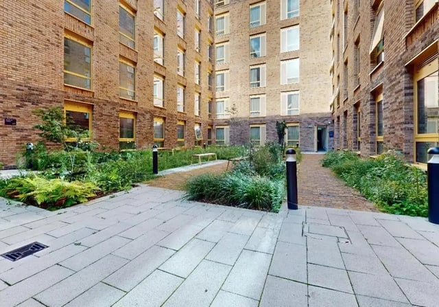Courtyard with brick buildings and green landscaping exterior at iQ Signal Place in Nottingham Student Accommodation