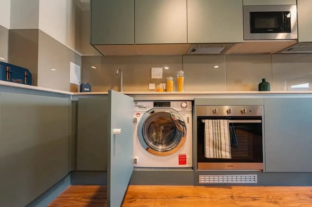 Washer oven microwave and cabinets kitchen at Redgate in Nottingham Student Accommodation
