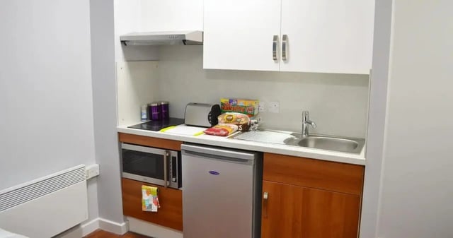 Compact kitchen with microwave fridge sink kitchen unit kitchen at Kaplan Living Nottingham in Nottingham Student Accommodation