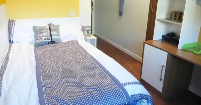Bed with city map pillow and patterned duvet Bedroom at Kaplan Living Nottingham in Nottingham Student Accommodation