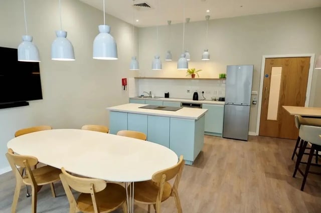 Dining table chairs kitchen island refrigerator kitchen living room at Wembley Barnard Point in London Student Accommodation
