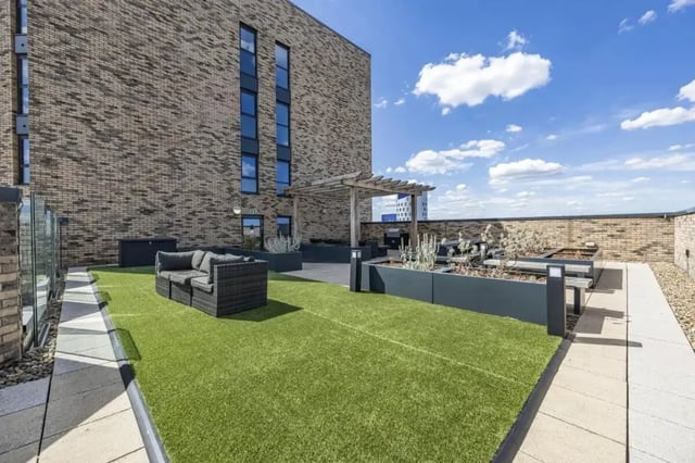 Rooftop seating area with green lawn and plants exterior at Wembley Barnard Point in London Student Accommodation