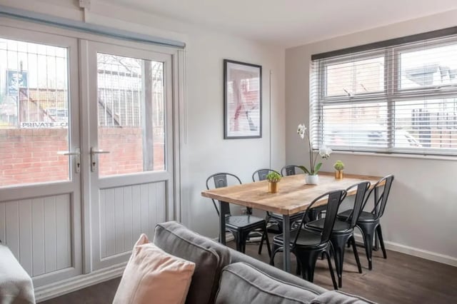 Wooden dining table with black chairs kitchen dining area at 28 Church Street in Nottingham Student Accommodation