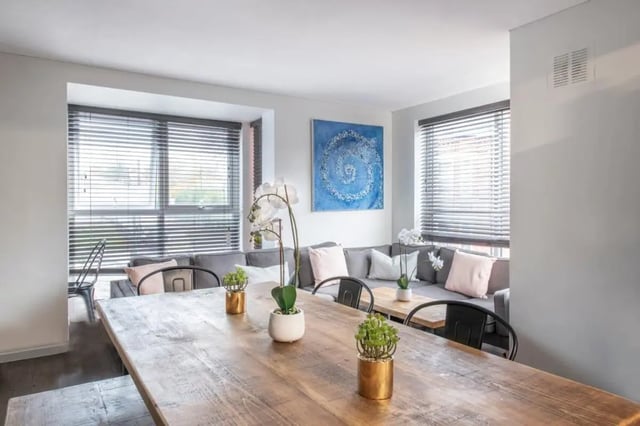 Dining table plants grey sectional sofa living room at 28 Church Street in Nottingham Student Accommodation