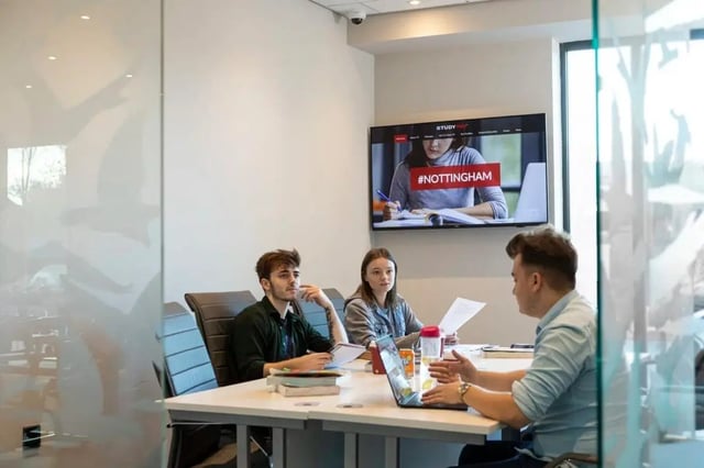 Students working at a table with laptop study area at Triumph House in Nottingham Student Accommodation