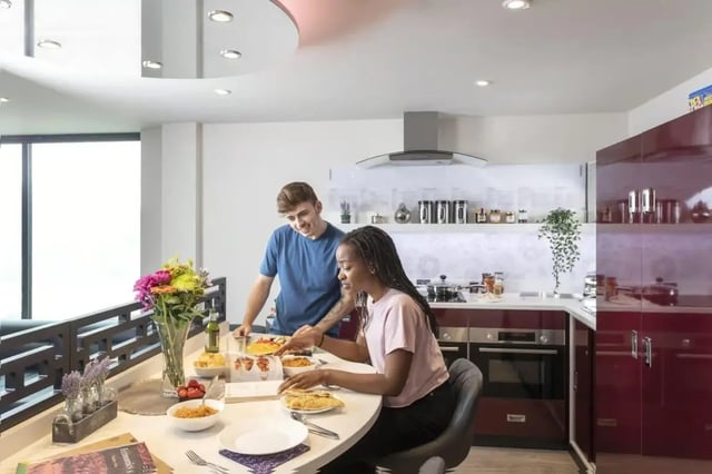 Couple preparing food at dining table kitchen at Triumph House in Nottingham Student Accommodation