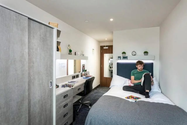 Closet bed desk man reading bedroom at Triumph House in Nottingham Student Accommodation