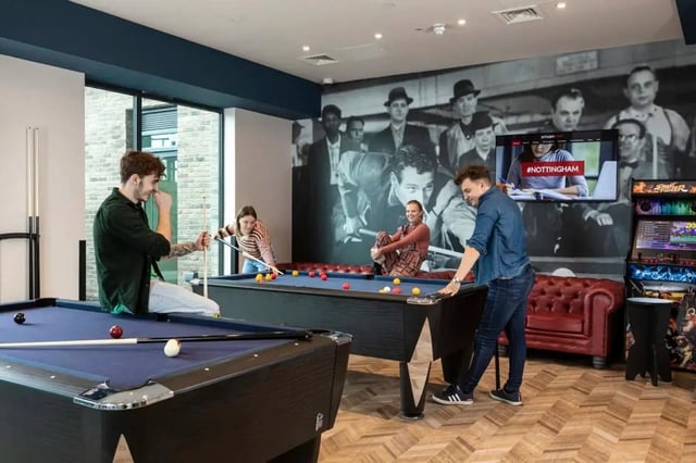 Students play pool in a recreational room at Triumph House in Nottingham Student Accommodation