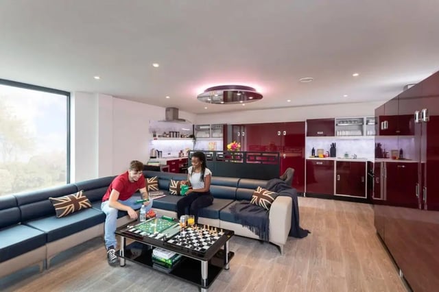 Students playing games on sofa kitchen area at Triumph House in Nottingham Student Accommodation