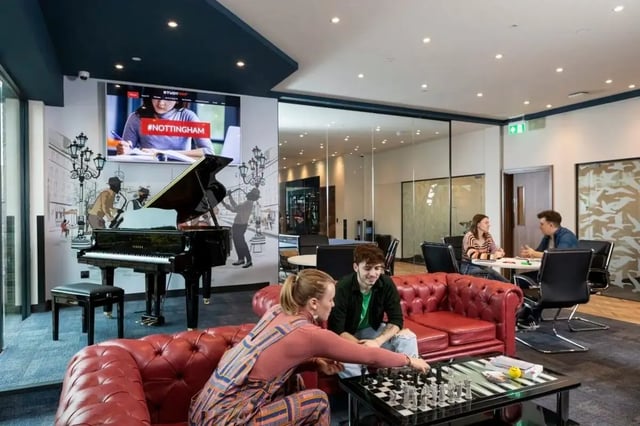 Grand piano red sofa chess board living room at Triumph House in Nottingham Student Accommodation