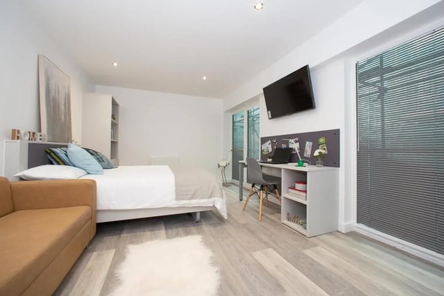 Bed desk TV couch rug bedroom living room at The Laceworks Nottingham in Nottingham Student Accommodation