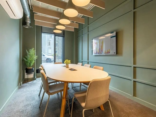 Meeting room with oval table chairs and screen Meeting room at Fabric in Nottingham Student Accommodation