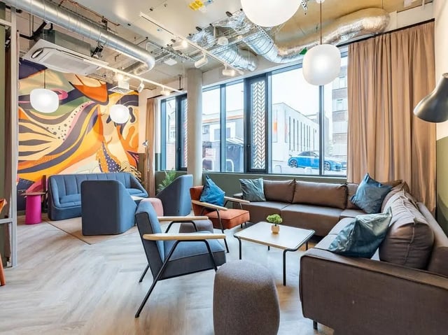 Sofa chairs with cushions and coffee table Living room at Fabric in Nottingham Student Accommodation