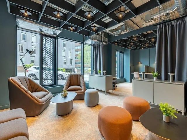 Chairs tables ottomans and desks common area at Fabric in Nottingham Student Accommodation