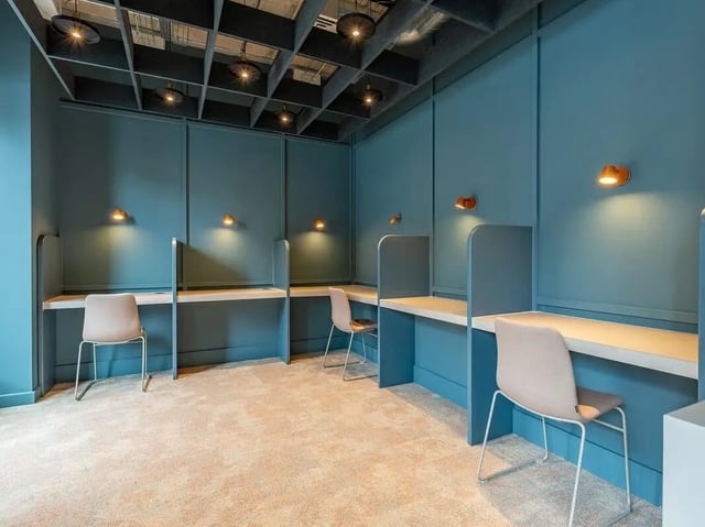 Study carrels with chairs carpeted floor study area at Fabric in Nottingham Student Accommodation