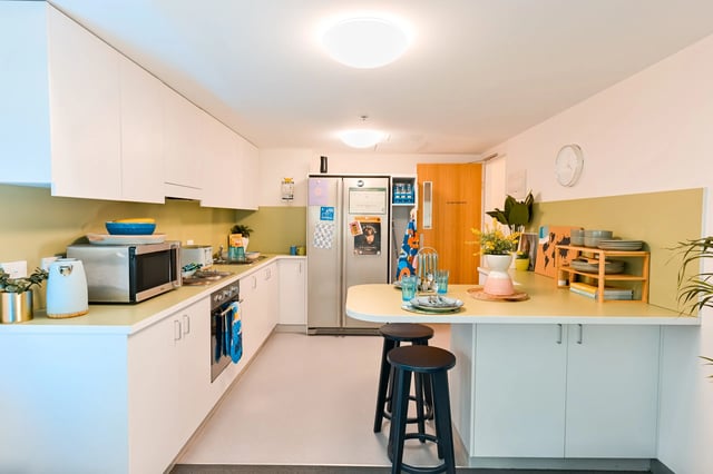 Modern kitchen with white cabinets and appliances kitchen at Scape Adelaide Central in Adelaide Student Accommodation