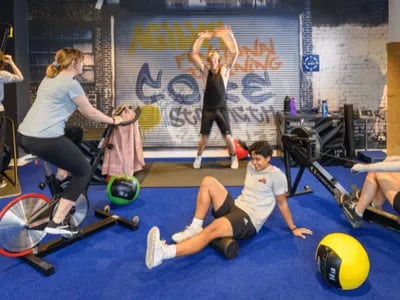 Gym with exercise bikes and people working out gymnasium at Unilodge South Bank in Brisbane Student Accommodation