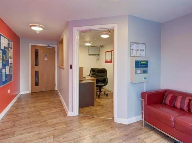 Reception desk office chair with red sofa Entrance at Abbeygate in Chester Student Accommodation