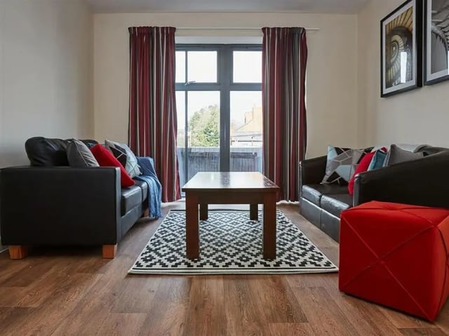 Two black sofas with patterned pillows and a living room at Abbeygate in Chester Student Accommodation