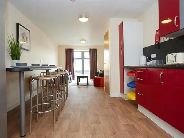 Kitchen area with stools and living room area kitchen at Abbeygate in Chester Student Accommodation