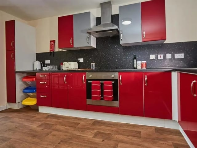 Red cabinets oven toaster kettle kitchen area at Abbeygate in Chester Student Accommodation