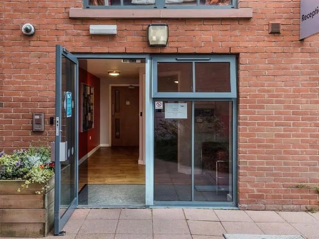 Glass entrance door with plants reception sign exterior at Abbeygate in Chester Student Accommodation