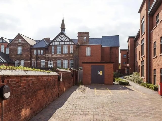 Brick buildings and parking lot exterior at Abbeygate in Chester Student Accommodation