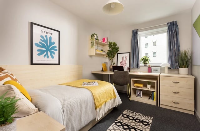 Bed desk chair and plants student bedroom at Grand Central in Liverpool Student Accommodation