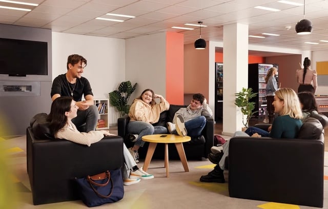 Students relaxing in a common area lounge at Grand Central in Liverpool Student Accommodation