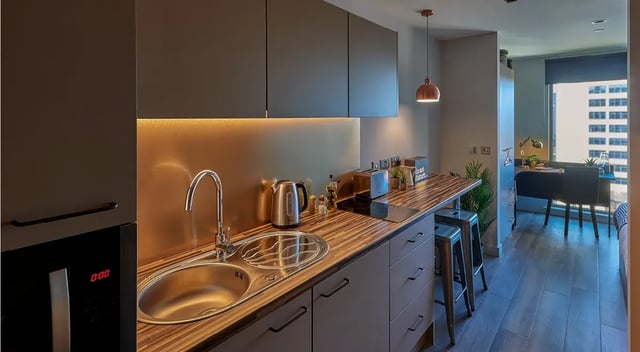 Modern studio kitchen with sink toaster kettle and desk at Cumberland Place in Southampton Student Accommodation
