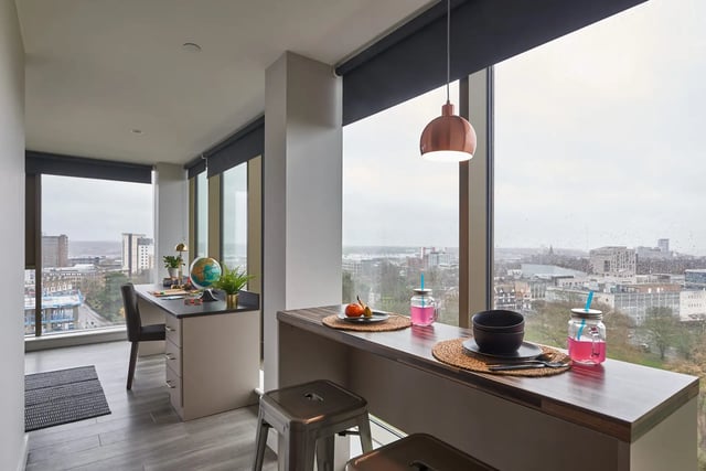 Desk globe lamp chair stools drinks kitchen bar at Cumberland Place in Southampton Student Accommodation