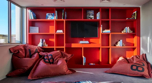 Beanbags and red bookshelf with television communal area at Cumberland Place in Southampton Student Accommodation