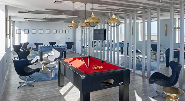 Pool table foosball chairs and tables common room at Cumberland Place in Southampton Student Accommodation