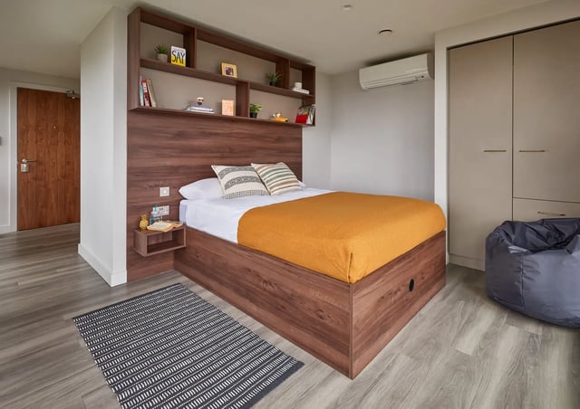 Bed with storage shelves and closet bedroom at Cumberland Place in Southampton Student Accommodation