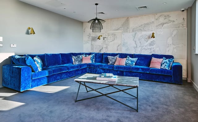 Blue sectional sofa maps on wall coffee table living room at Cumberland Place in Southampton Student Accommodation