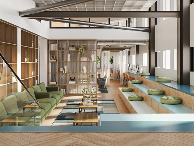 Green sofa bookcases study desks tiered seating common area at Telephone House in Dundee Student Accommodation
