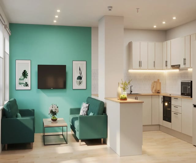 Two sofas television wall art and kitchen living room at Telephone House in Dundee Student Accommodation