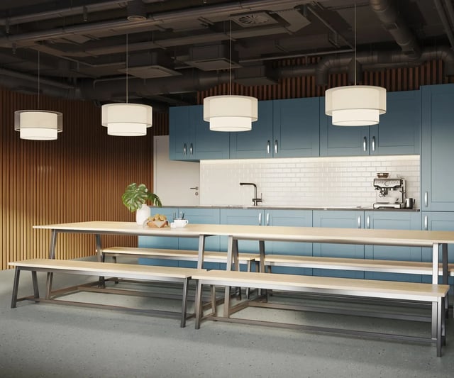 Shared dining tables with benches kitchen area at Telephone House in Dundee Student Accommodation