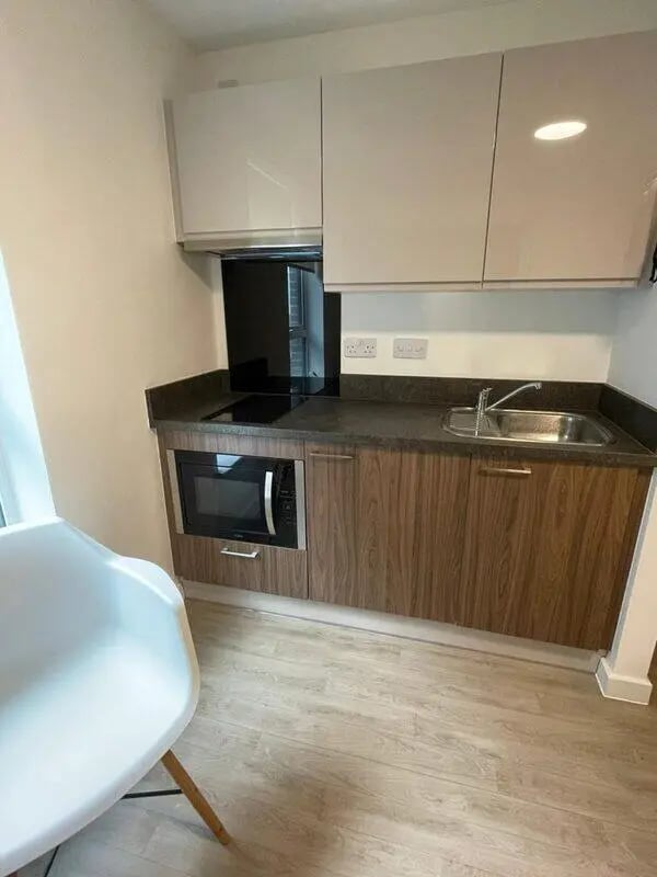 Microwave stovetop sink white cabinets kitchen at Phoenix Place in Liverpool Student Accommodation
