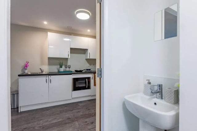 White cabinets sink microwave kitchen area and bathroom sink at One Islington Plaza in Liverpool Student Accommodation